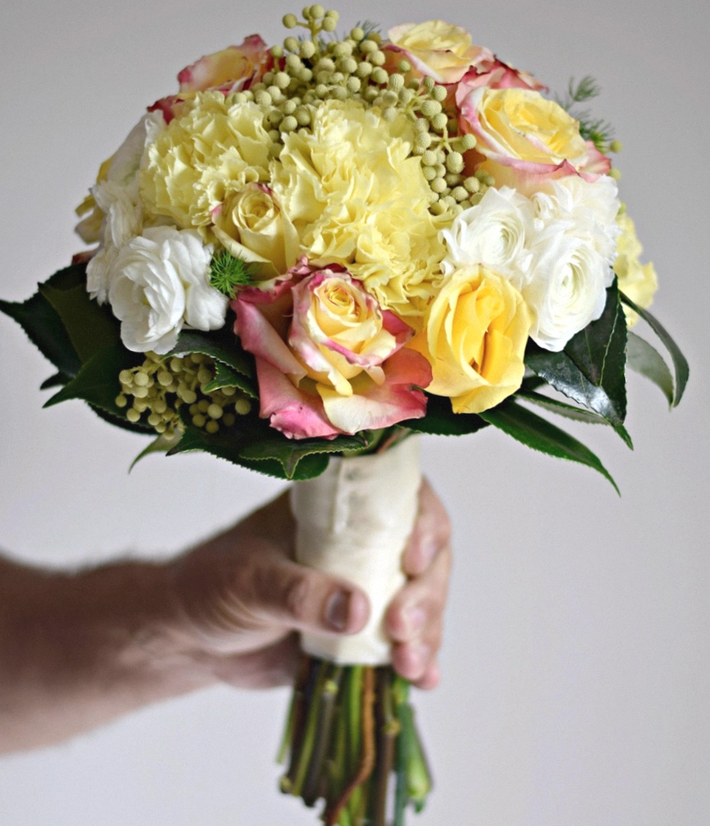 Theo adjusting a bouquet for a student
